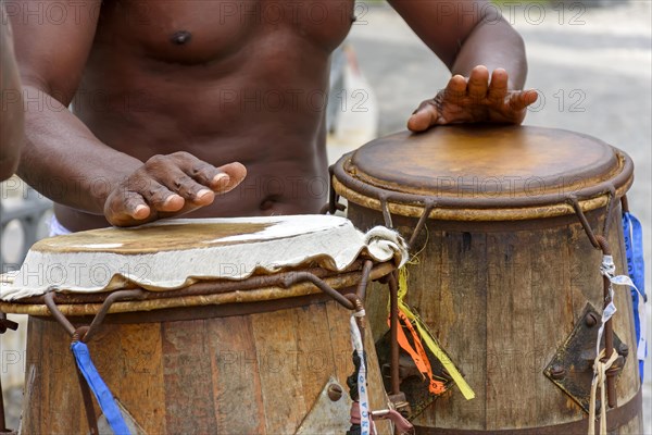 Musician playing atabaque which is a percussion instrument of African origin used in samba