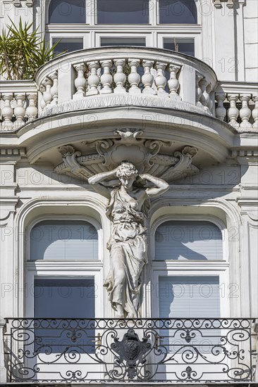 Baroque statue as support of a balcony on the left Wienzeile