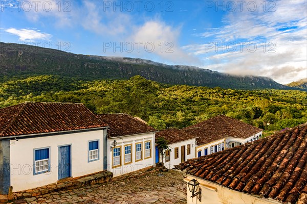View of the old historic city of Tiradentes with its historic colonial-style houses and mountains in the background during the afternoon in Minas Gerais
