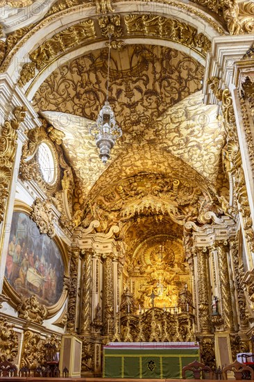 Interior and altar of a brazilian historic ancient church from the 18th century in baroque architecture with details of the walls in gold leaf in the city of Tiradentes