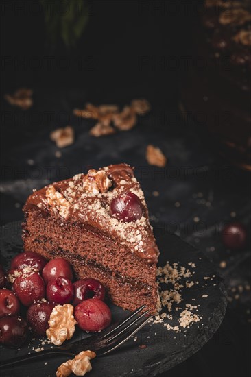 Chocolate cake with nuts and cherries