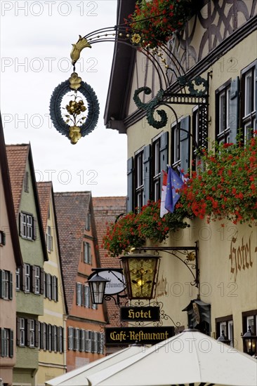 Late medieval townscape with hotel and nose sign