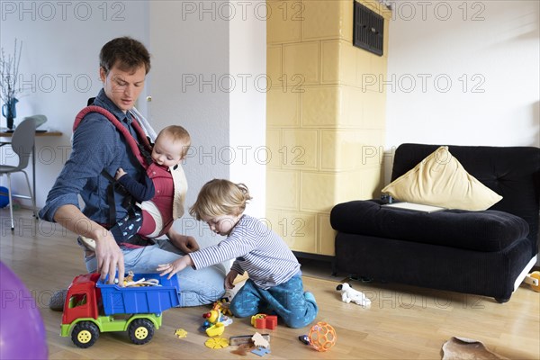Subject: Father with two children aged nine months and three years.