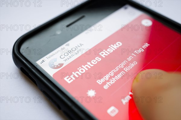 The Corona Warn app displays the words Increased Risk on a smartphone. Berlin