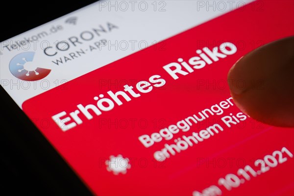 The Corona Warn app displays the words Increased Risk on a smartphone. Berlin