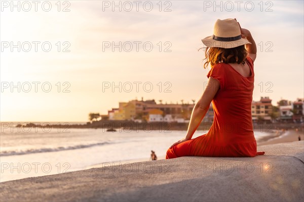 Tourist woman at sunset enjoying vacations on the beach of Valle Gran Rey village in La Gomera