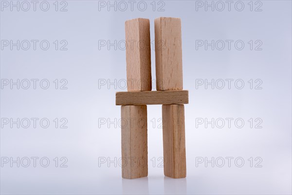 Wooden domino pieces positioned on white background