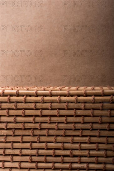 Straw mat and brown background for background usage