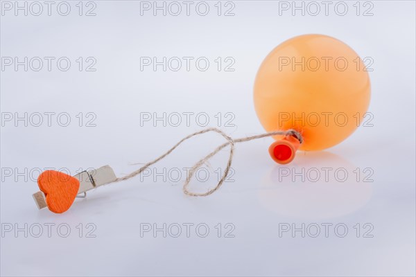 Clothespin with a heart tied to a balloon with a string