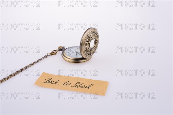 Back to school written title and a pocket watch