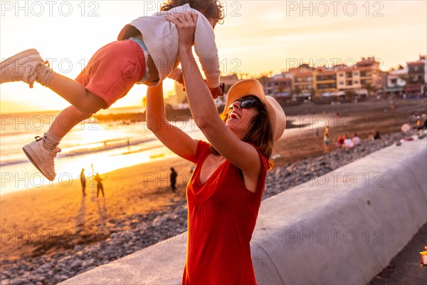 Mother and son at sunset on the beach of Valle Gran Rey in La Gomera