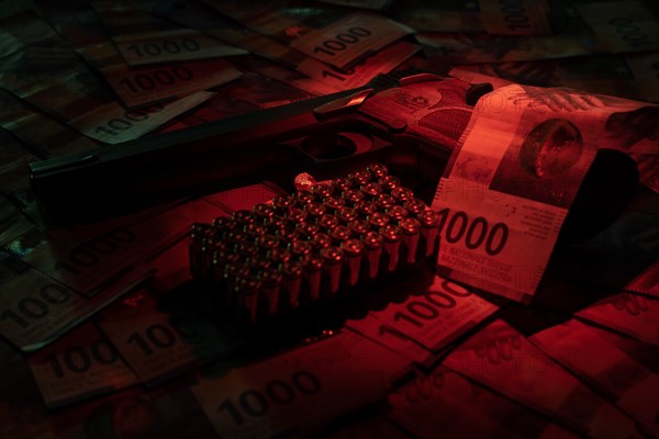 Elegant Semiautomatic 9mm Handgun with Swiss Helvetia Symbol Leaning on Swiss Franc 1000 Banknote and Bullet Ammunition in Switzerland