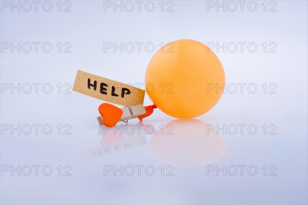 Help word on a piece paper with a heart and a balloon