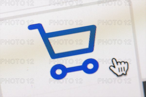 Symbol photo on the subject of online shopping. The symbol of a shopping cart and a mouse pointer can be seen on the display of a computer. Berlin