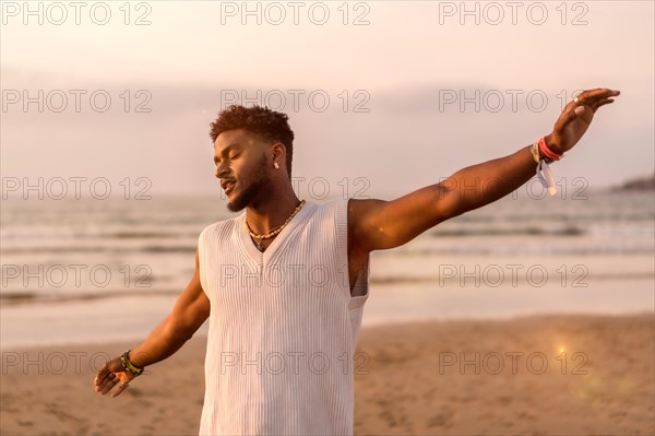 Portrait of black ethnic model enjoying summer vacation by the sea feeling free