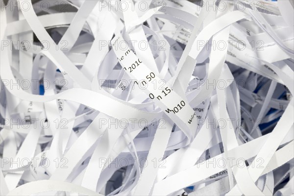 Paper strip documents made unrecognisable in the shredder
