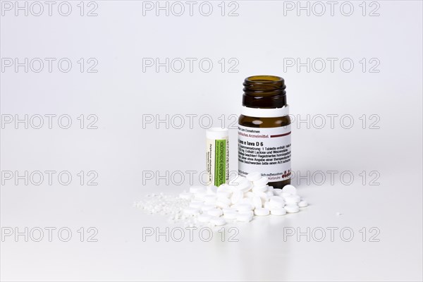 Homeopathic remedies lie in front of containers
