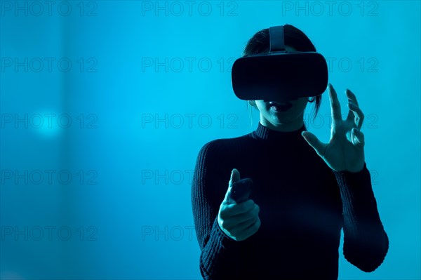 Metaverse technology concept. Woman with virtual reality VR glasses. Futuristic lifestyle