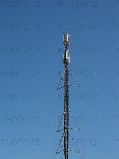 Aerial antenna tower over blue sky