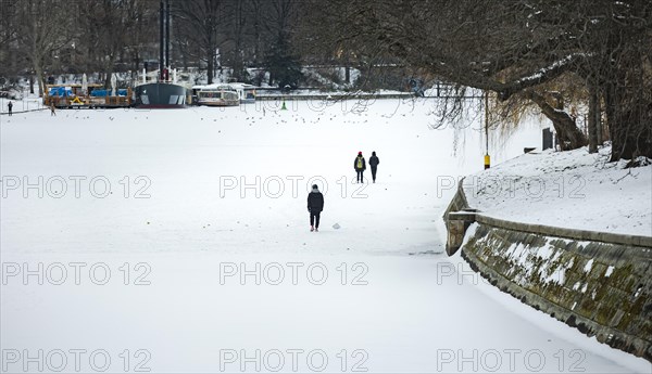 People walk on the frozen Landwehrkanal in Berlin. 11.02.2021.