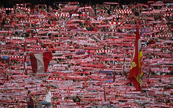 Fans hold up scarves