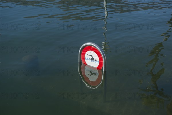 Signboard on flooding alpine lake Lago Maggiore