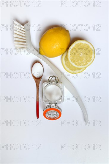 Citric acid in wooden spoon and glass container