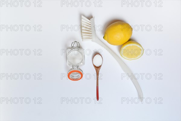 Citric acid in wooden spoon and glass container