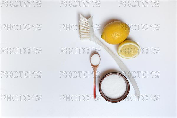Citric acid in wooden spoon and small bowl