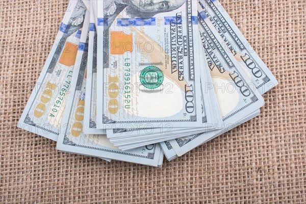 Banknote bundle of US dollar placed on a linen canvas