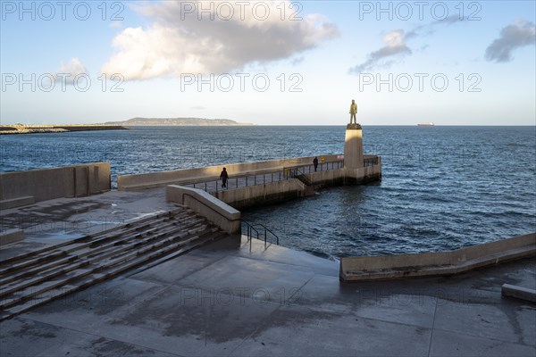 Walkers near the Roger Casement statue at Dun Laoghaire baths enjoy a fresh