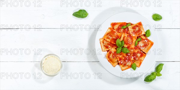 Ravioli Italian pasta eat lunch dish with plate in tomato sauce from above on wooden board copy space Copyspace in Stuttgart