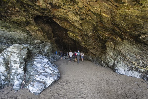 Tourists walk the fabled Merlins Cave