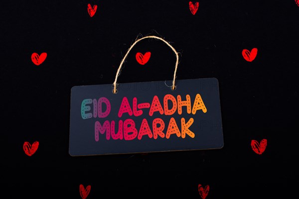 Rectangular shaped black notice board and red hearts on black background