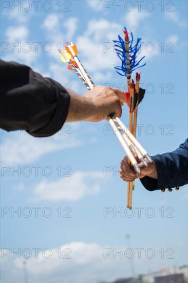 Hand holding old style wooden arrows