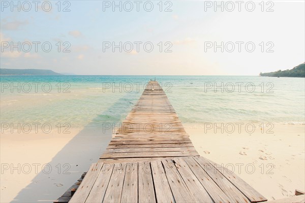 A wooden boardwalk leading to the white sand beach of Koh Rong Samloen Island in Cambodia