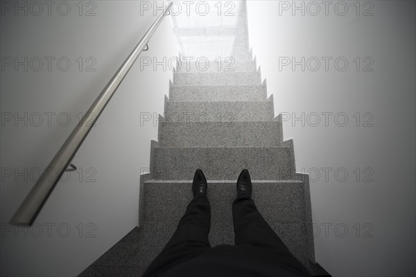 Man standing in the staircase with window light