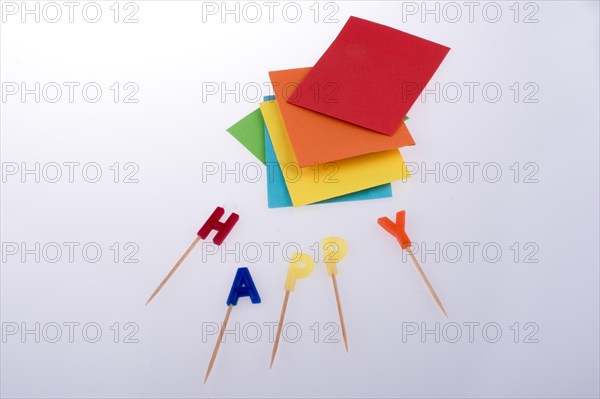 Colored envelopes and Color candles on sticks write happy