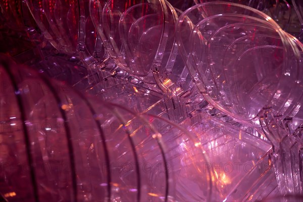 Illuminated Red Plastic Chairs Stacked in Switzerland