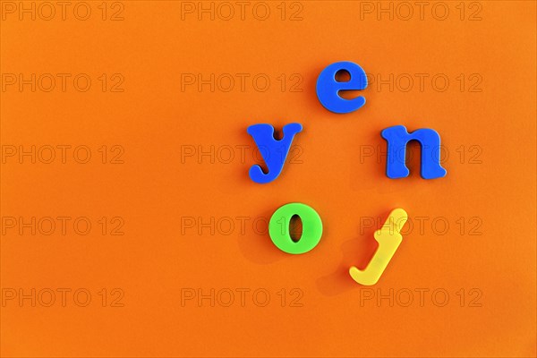 Colourful letters form the word enjoy