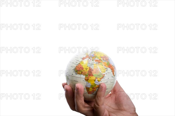 Child holding a small model globe in hand on white background