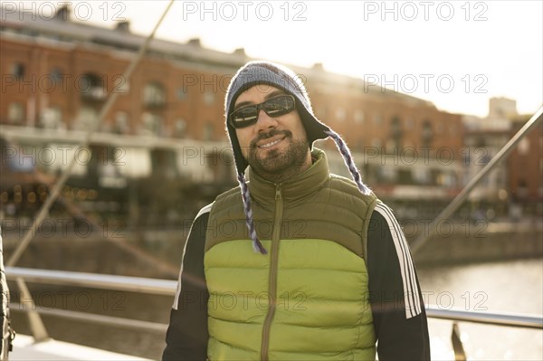 Portrait of a good looking latin man tourist looking at camera in Puerto Madero