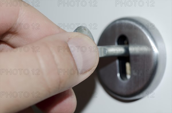 Hand Turns the Key in the Lock