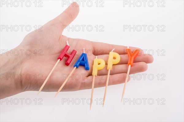 Color candles on sticks write the word happy
