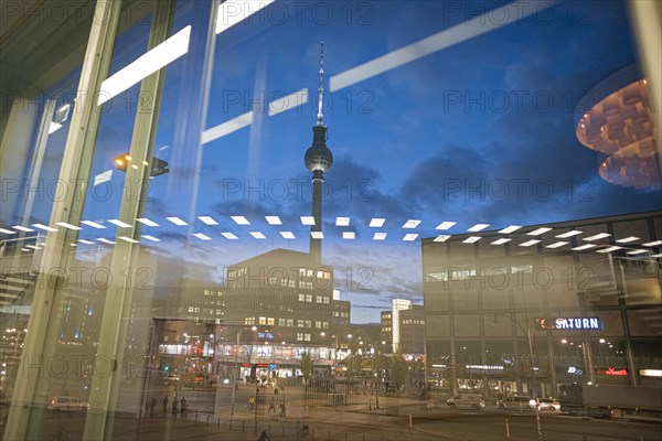 The TV tower at Alexanderplatz is reflected in a disc at blue hour. Berlin