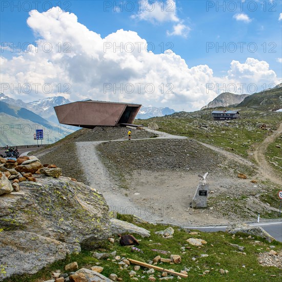 View on the left Pass Museum rises on pass height of 2509 metres high Timmelsjoch Passo Rombo from right Austrian territory to left in air of Italian territory