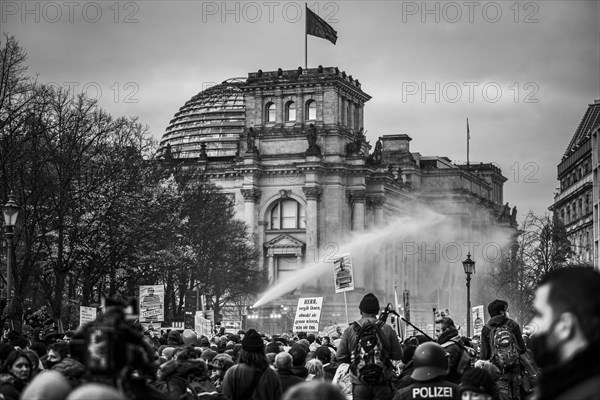 Police officers act with water cannons against demonstrators protesting against the reform of the infection protection law in Berlin