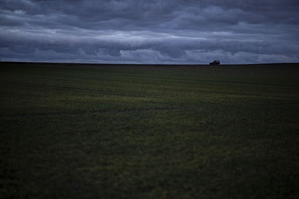 A car stands out on a country road at blue hour in Vierkirchen