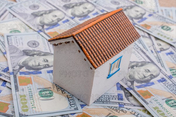 Model house is placed US dollar Banknotes on spread on the background
