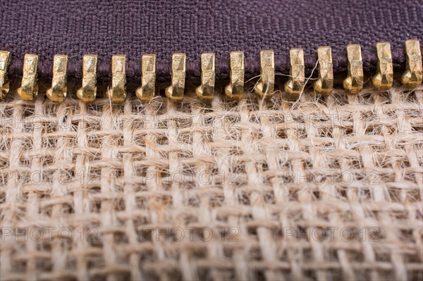 Closeup of a colorful zipper on linen canvas